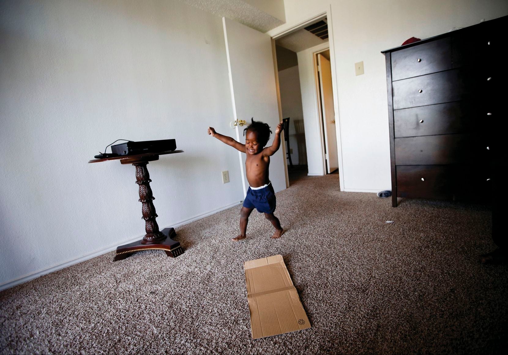 Jordan Miller, 2, runs in circles at his new apartment in Dallas. His father, Joshua Miller, said the new space has his son acting like a 2-year-old again. Before moving into the one-bedroom unit, the Millers lived in a small room at the Family First Men's Shelter.