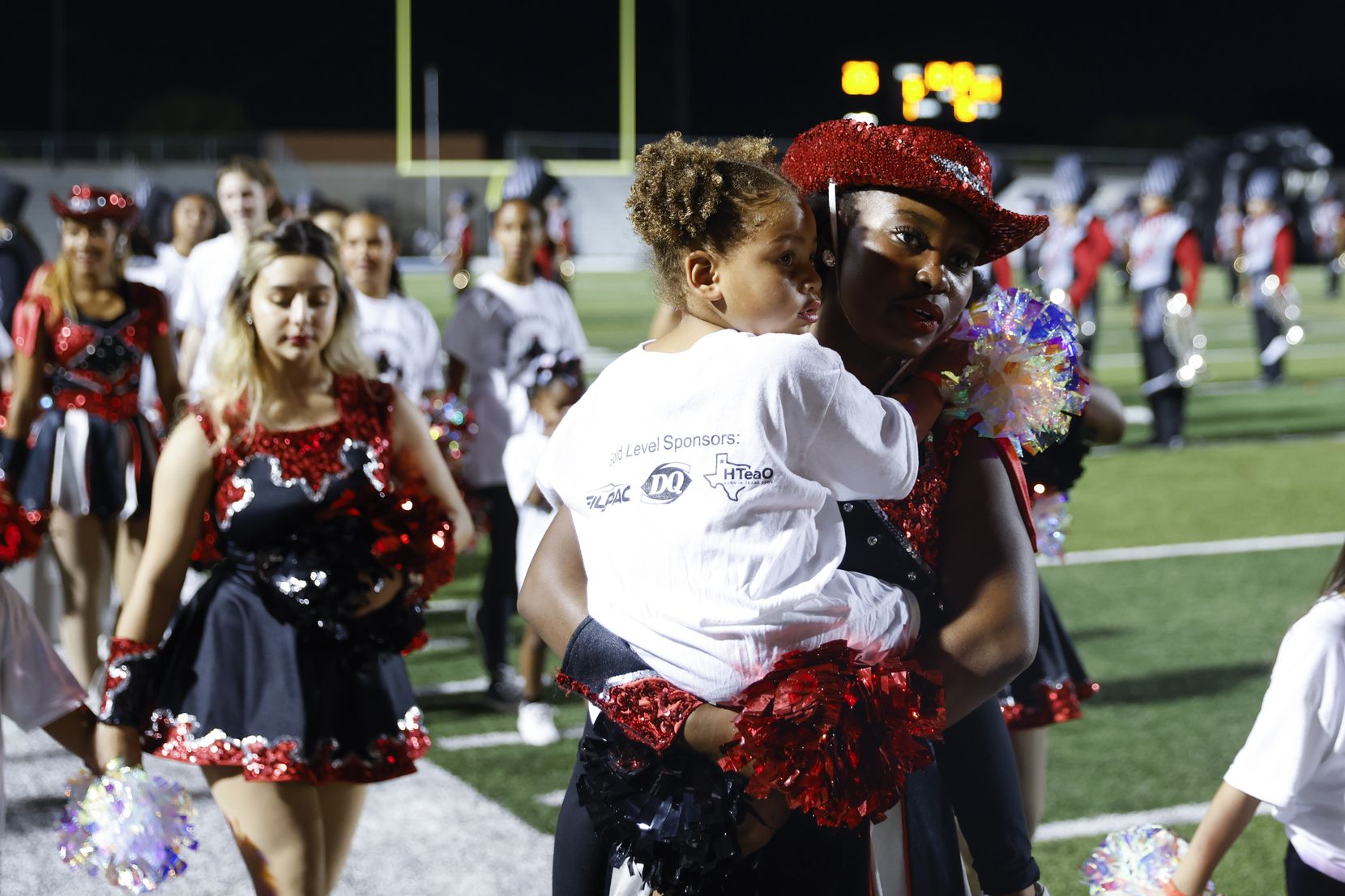 Trinity High’s Troy-Anns team head back after performing in the half time show during a...