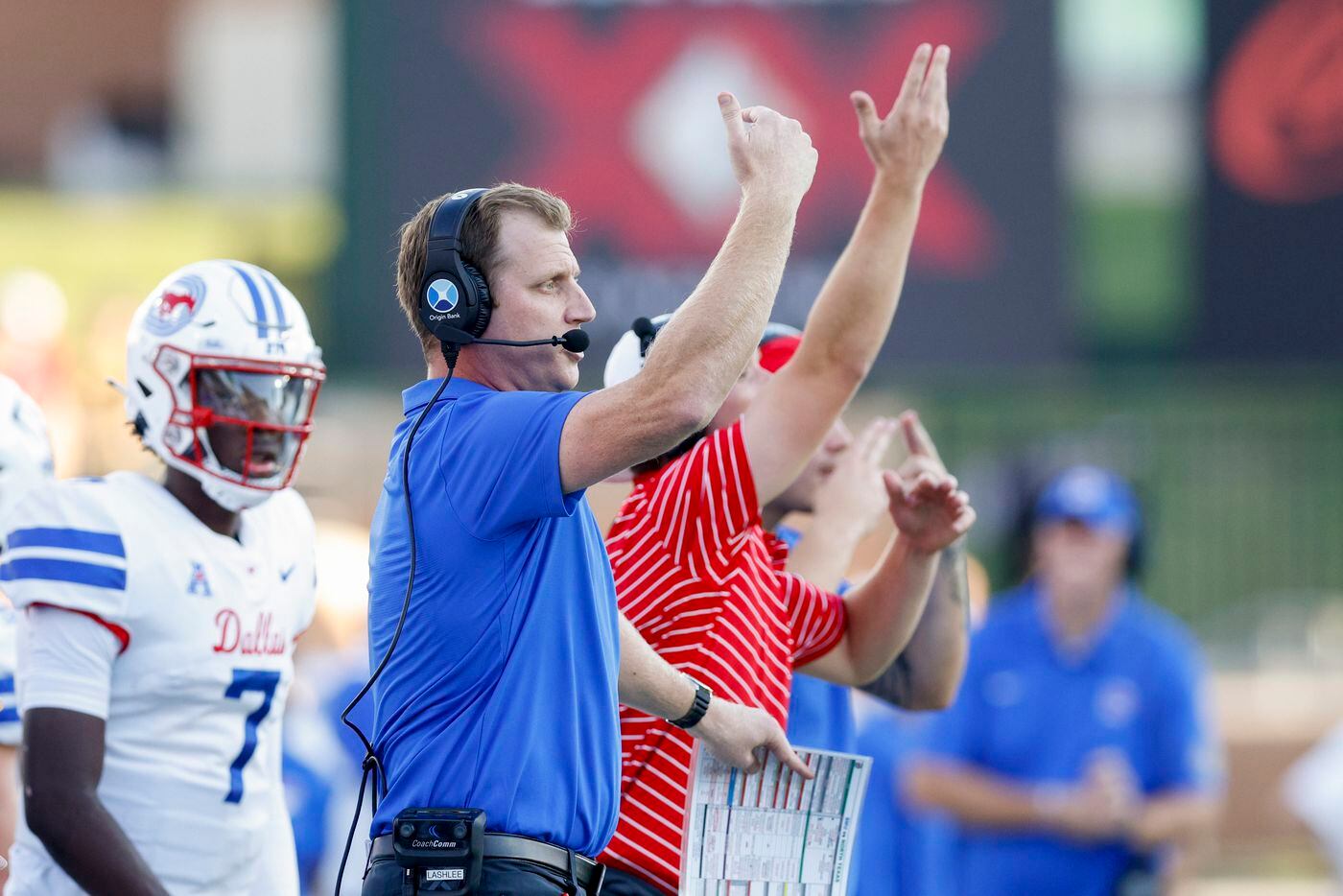 SMU head coach Rhett Lashlee signals to his players during the first quarter of a game...