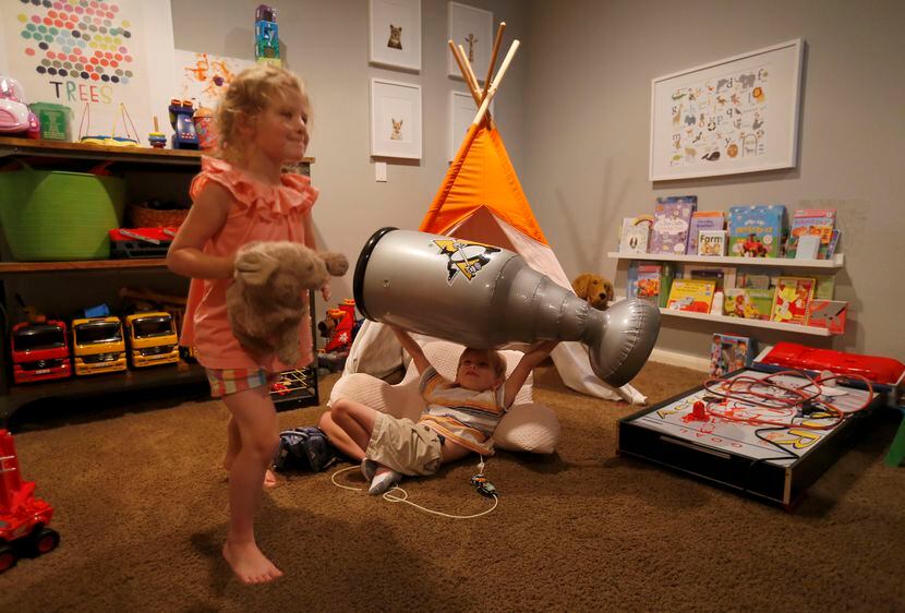 Will plays with his sister, Lauren, in the playroom at their home in McKinney, Texas, on...