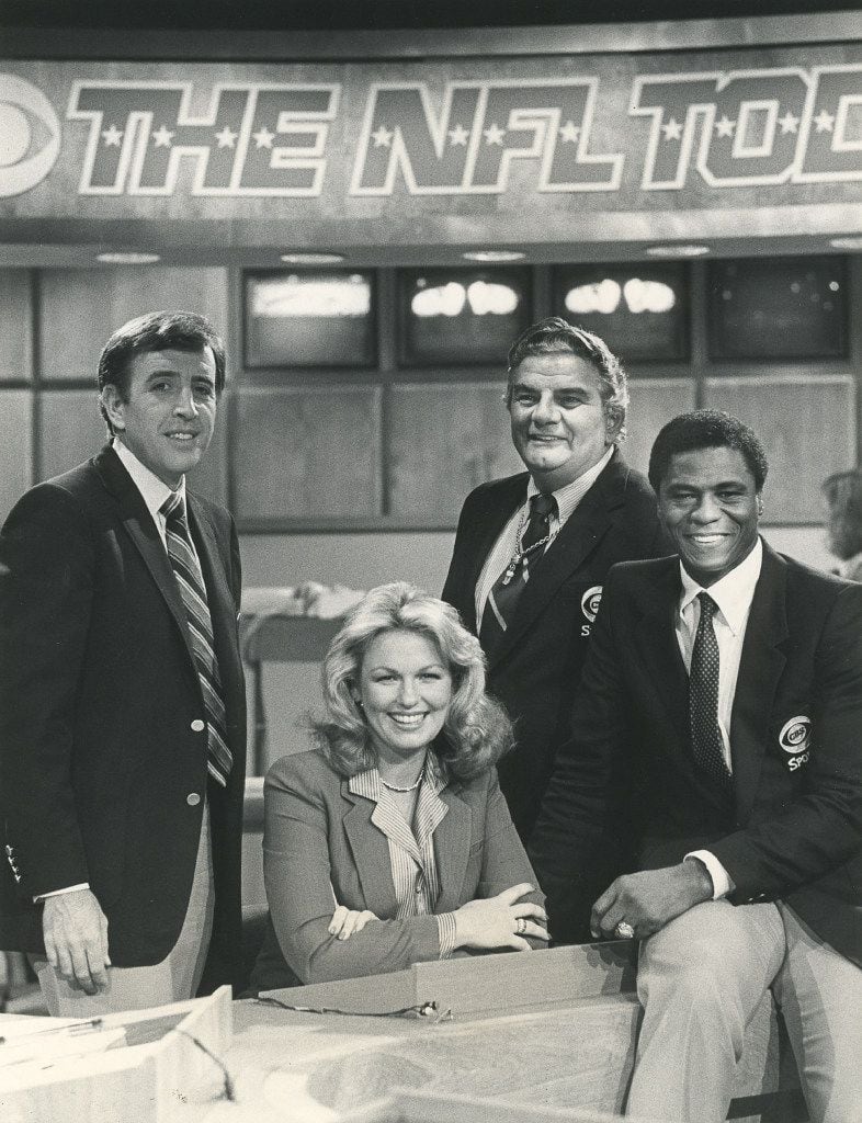 In 1975, Phyllis George joined the team of Brent Musburger (left) and Irv Cross (far right)...