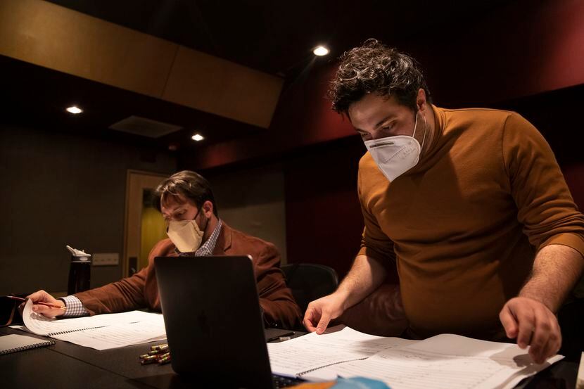 Producer Anthony Maglione (left) and artistic director Sam Brukhman review scores as members...