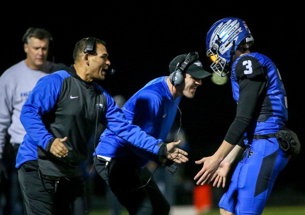 North Forney quarterback Jacob Acuna (3) celebrates with his coaches after scoring a...