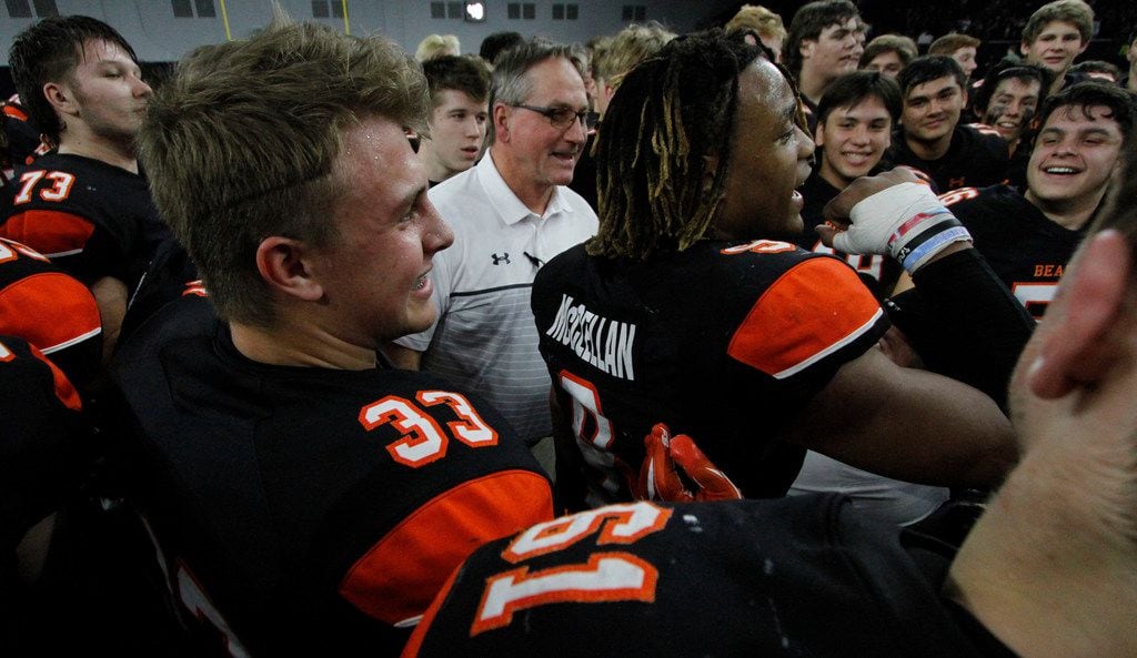 Aledo head coach Tim Buchanan, center, celebrates as running back Jase McClellan (9) leads a cheer at midfield following the Bearcats 43-36 overtime victory over Ennis to advance.  The two teams played their Class 5A Division ll Regional final playoff football game at Frisco Center at The Star in Frisco on December 6, 2019. (Steve Hamm/ Special Contributor)
