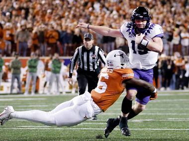TCU Horned Frogs quarterback Max Duggan (15) is tackled in the open field by Texas Longhorns...