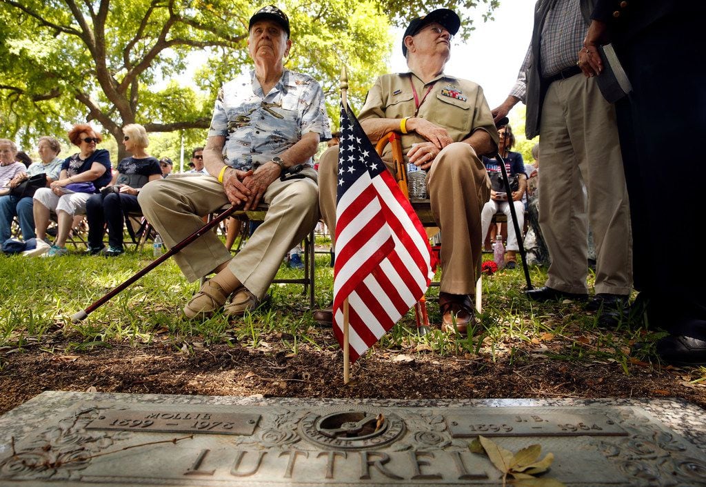 World War II veterans Jim Patterson (left) and Jimmy Holmes visit with folks among the...