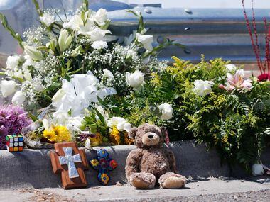 Flowers and other items were left near an entrance to the Walmart where the massacre happened.