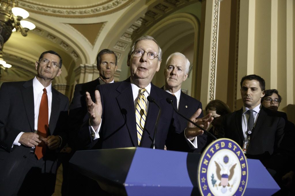 In this file photo, Senate Minority Leader Mitch McConnell, R-Ky.,  center, talks to...