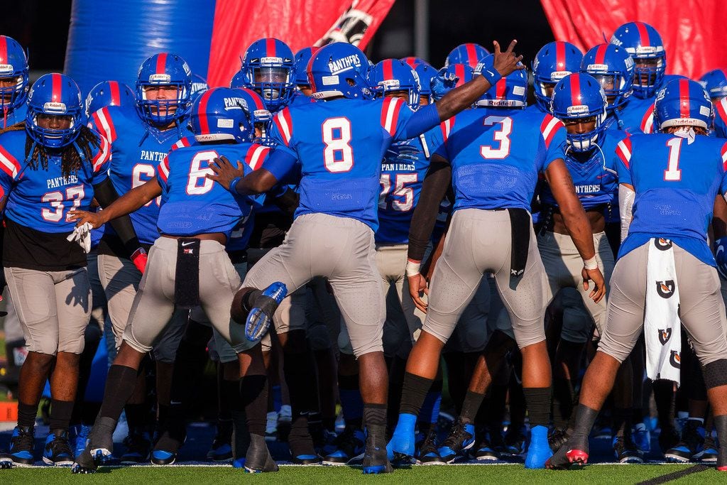 Duncanville players prepare to take the field to face St. John's College (D.C.) in a high...