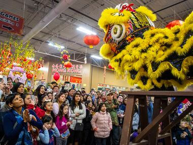 Spectators watch as members of the Jiu Long Sports Association put on a performance during the Lunar New Year festival at Asia Times Square in Grand Prairie.