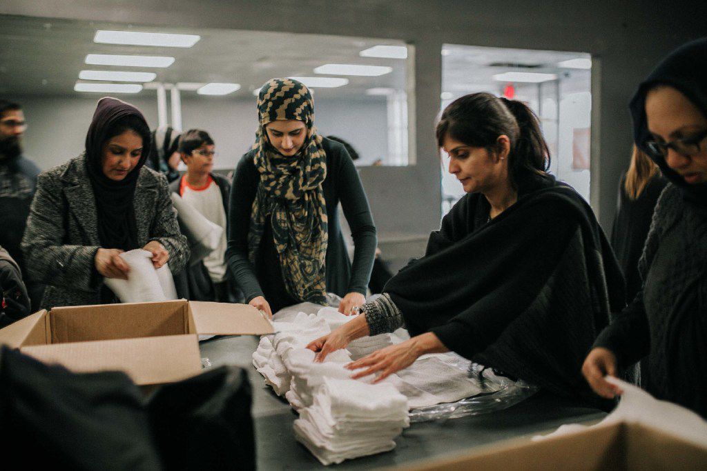 Muslim volunteers in Allen pack survival kits for the homeless in Dallas on an overcast...