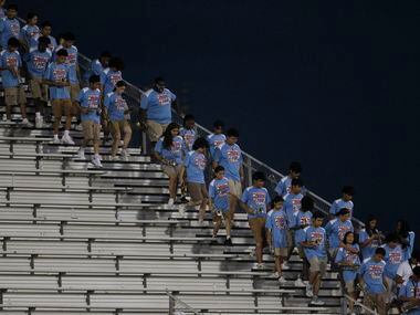 Members of the Dallas Skyline band exit the stands in preparation for their performance on...