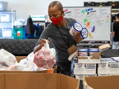 Volunteer Dineo Gaofhiwe-Ingram gathered items like cottage cheese and fruits for packing into boxes to be given to families in need at Crossroads Community Services on Wednesday, Nov. 17, 2021. “I wanna help and make a difference because there’s a need,” Gaofhiwe-Ingram said. “That's really why I'm doing it. Just to help.”