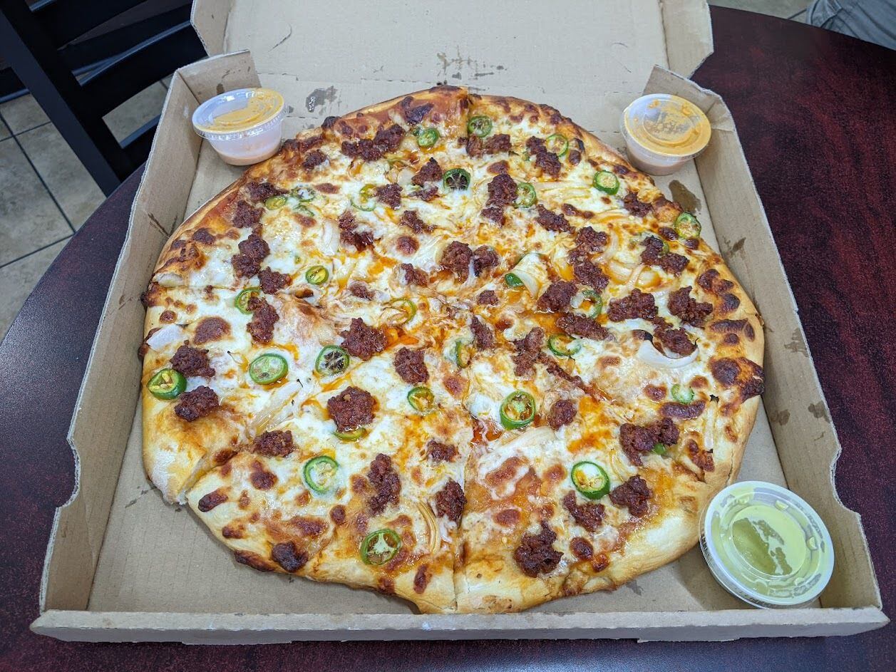 The greasy but punchy chorizo and jalapeño pizza at Pizza y Tacos El Rancho. A word of...
