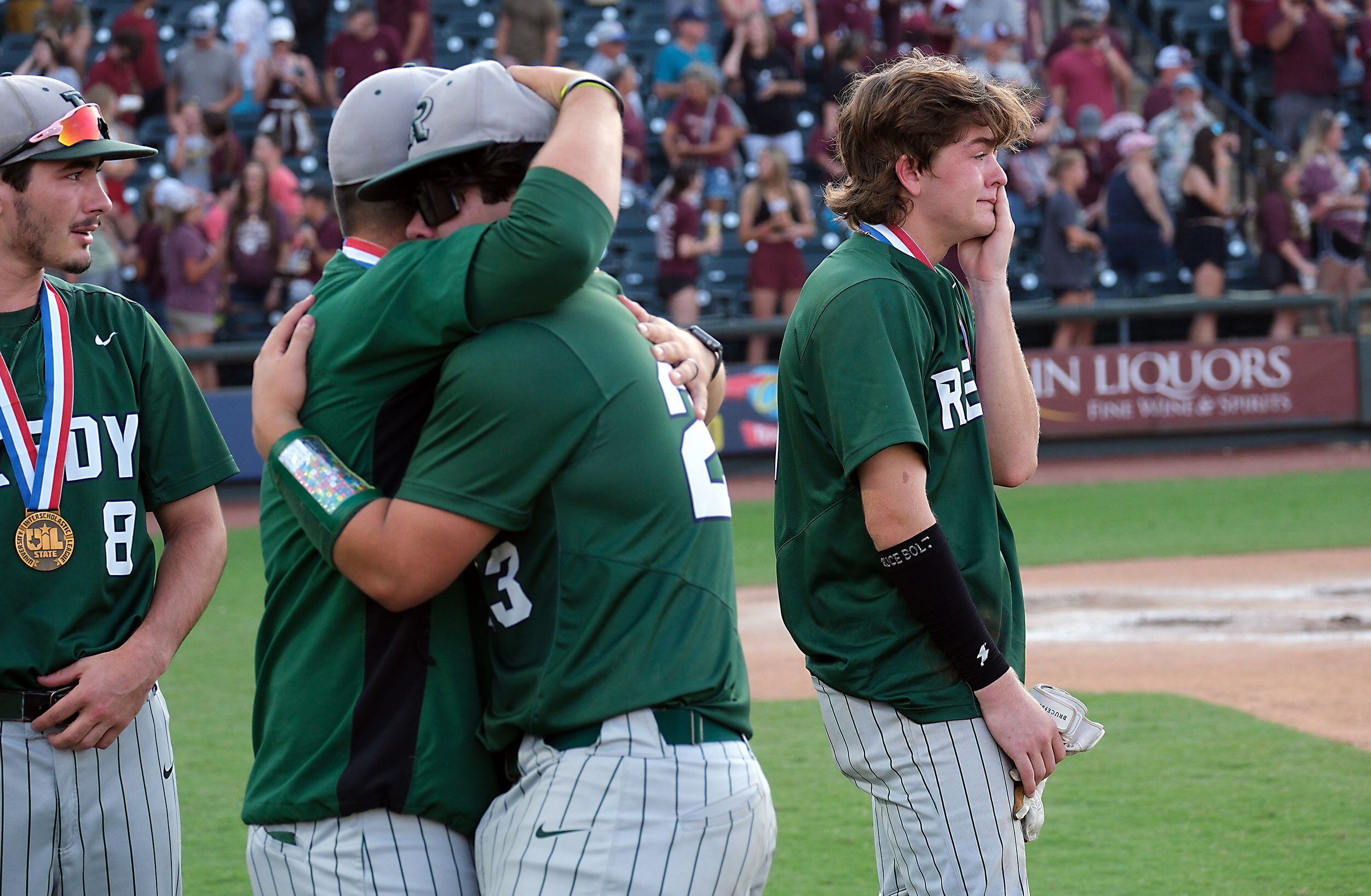 Frisco Reedy Brandon Huff, (11), right, and Caden Jones, (23), are overcome with emotion...