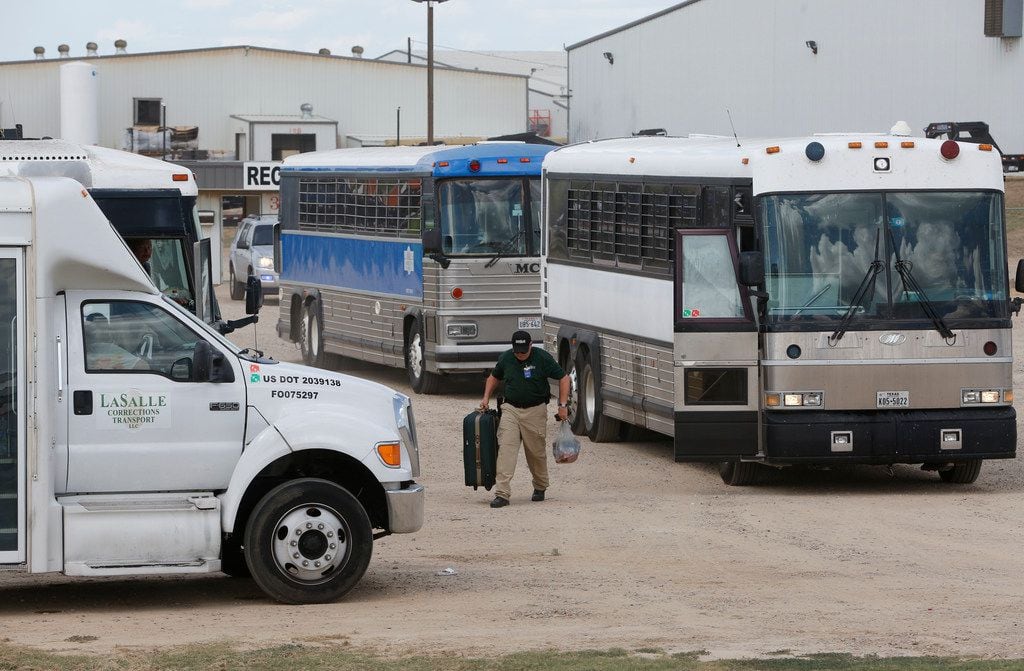 Buses loaded with detained employees exited after Immigration and Customs Enforcement raided...
