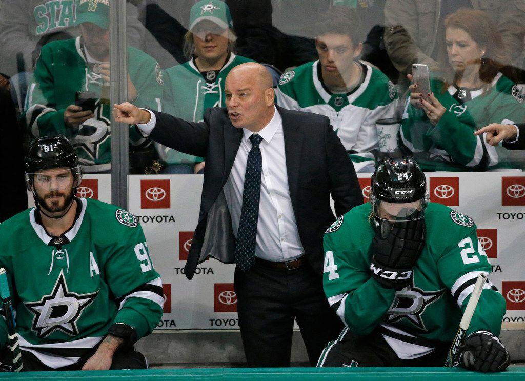 Dallas Stars head coach Jim Montgomery makes a point to his players late in the third period...