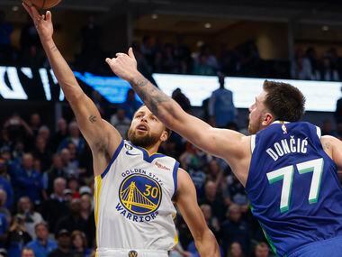 Dallas Mavericks guard Luka Doncic (77) contests a shot from Golden State Warriors guard...