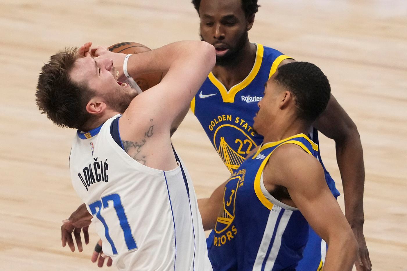 Dallas Mavericks guard Luka Doncic (77) has the ball knocked away by Golden State Warriors...