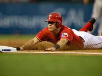 Texas Rangers' Ian Kinsler (5) slides safely into third on a Elvis Andrus double against the...