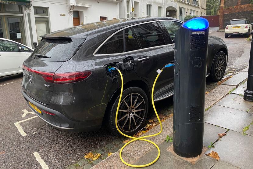 An electric vehicle charges at a public fast-charging station in London on Oct. 20, 2022....