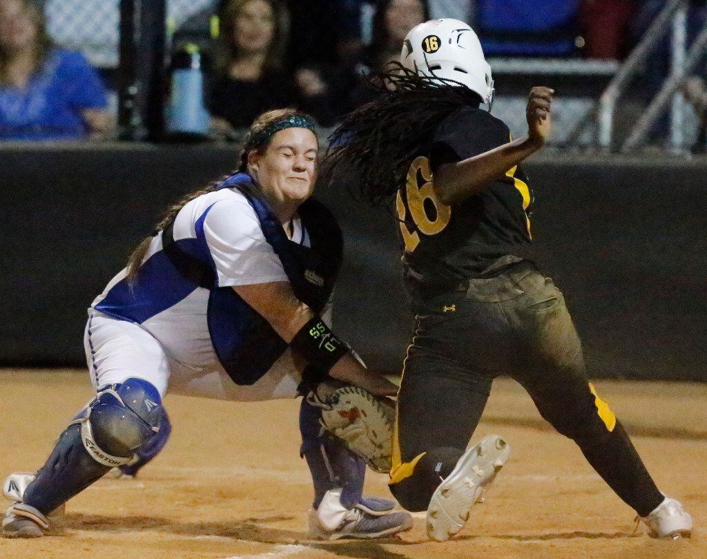 Plano West catcher Tatum Boyd (2) puts the tag on Plano East third baseman Mo Dickerson (16) at the plate for the third out of the inning as Plano West High School hosted Plano East High School in softball game on, March 21, 2017. (Stewart F. House/Special Contributor)