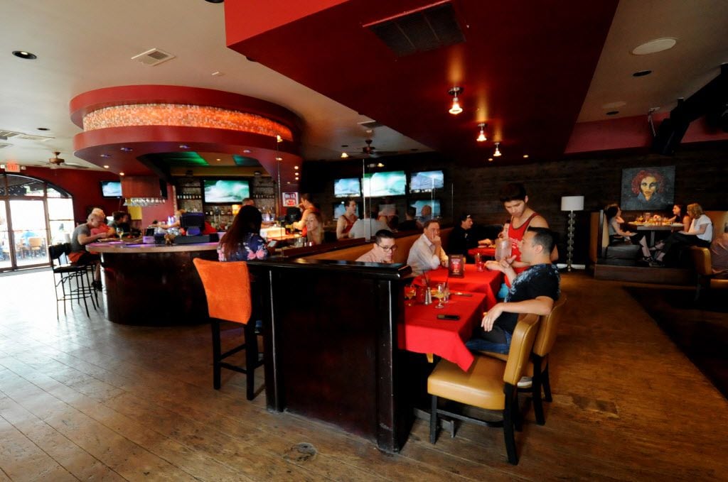 Guests sit at the bar or in the dining area for drinks and American cuisine at Tallywackers...