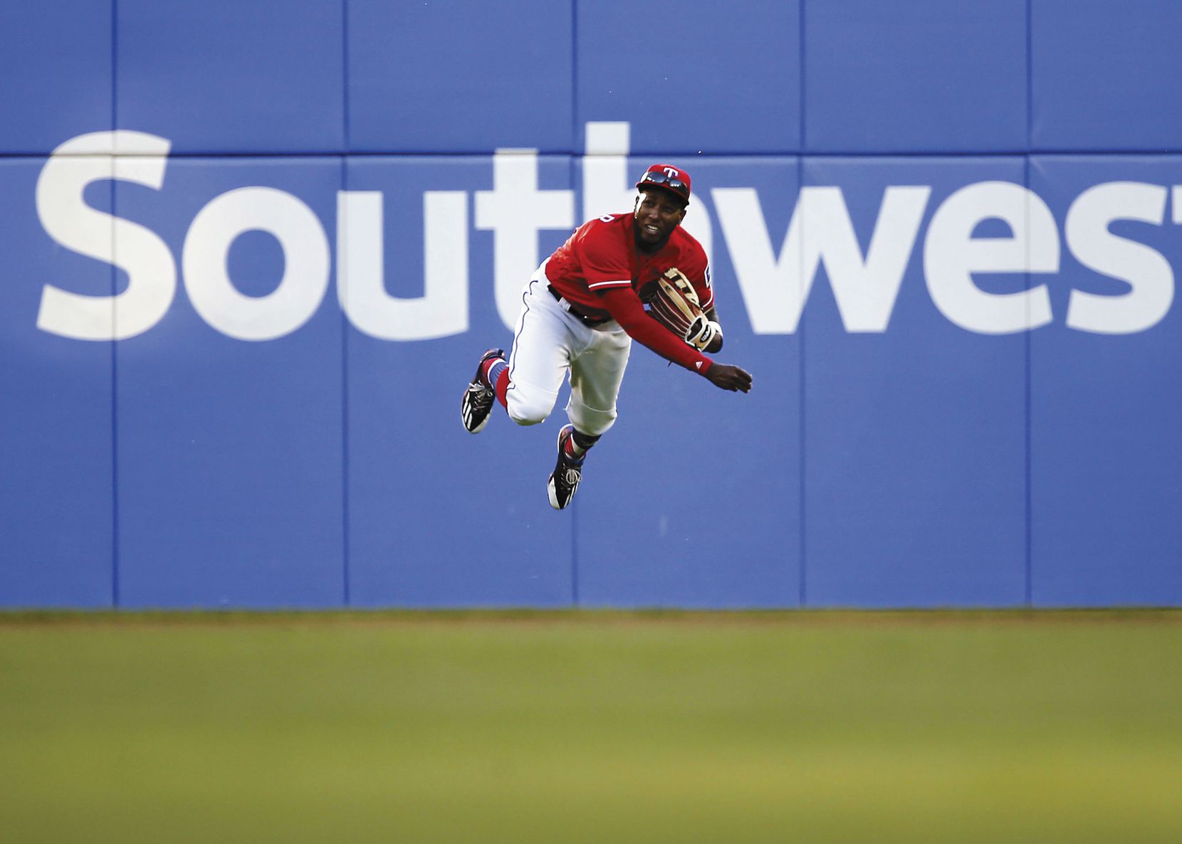 Rangers left fielder Jurickson Profar goes flying to return a ball in the third inning against the Indians on Opening Day on April 3.