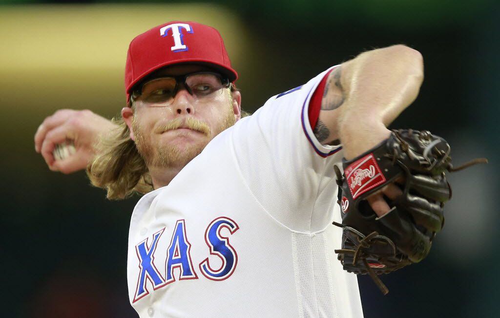Texas Rangers starting pitcher A.J. Griffin throws in the first inning against the New York...