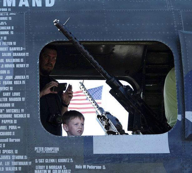 A boy looks out of a gunners window in a B-24 at the Wings of Freedom Tour. 
