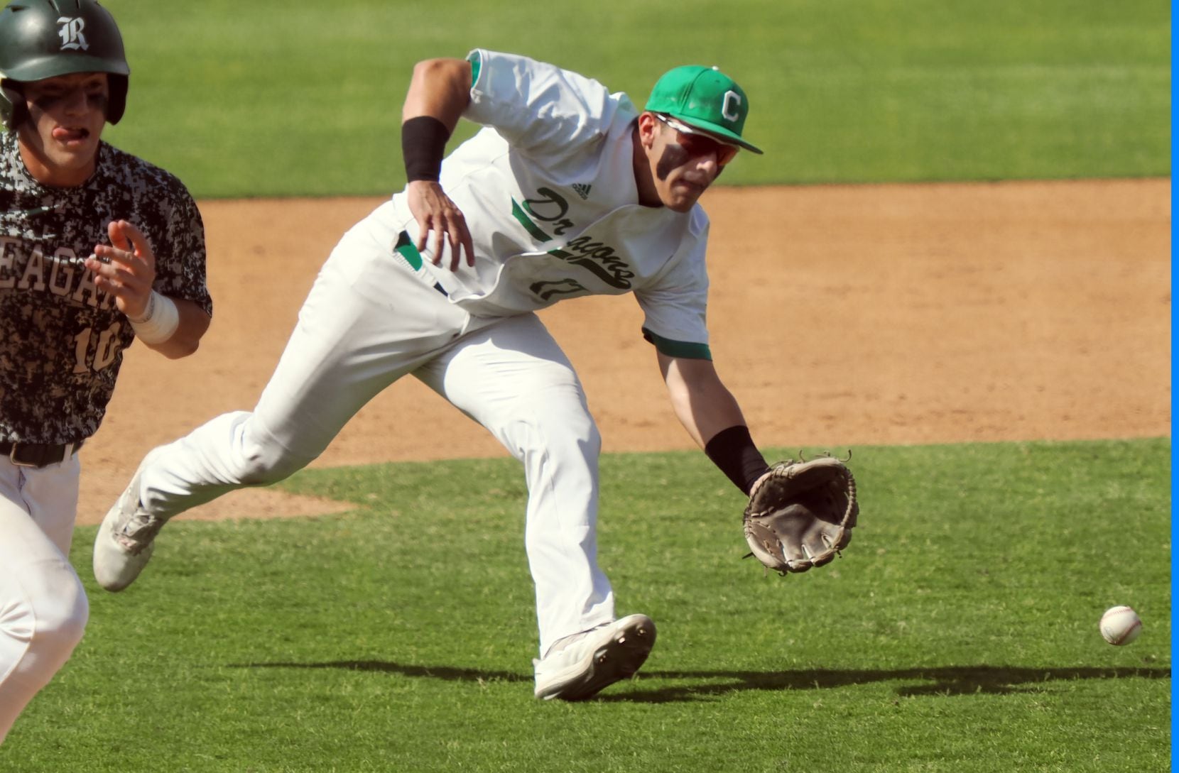 Southlake Carroll third baseman Cole Bedwell (17) scoops up a bunted ball against San...