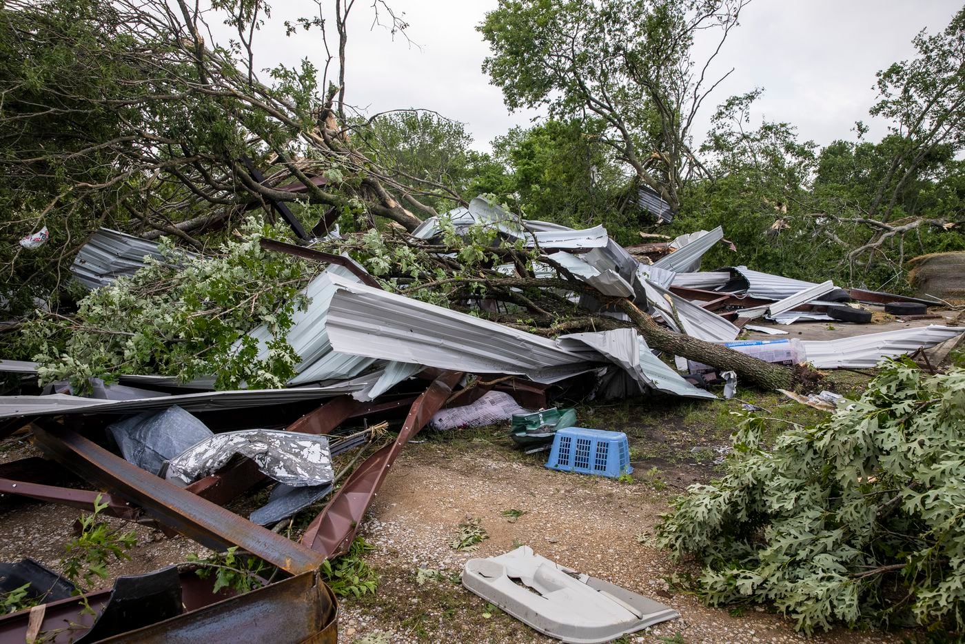 The detritus of an auto parts shop landed across the road in a neighbor’s property in the aftermath of a Monday night tornado that touched down just south of Waxahachie, Texas, on Tuesday, May 4, 2021. (Lynda M. González/The Dallas Morning News)