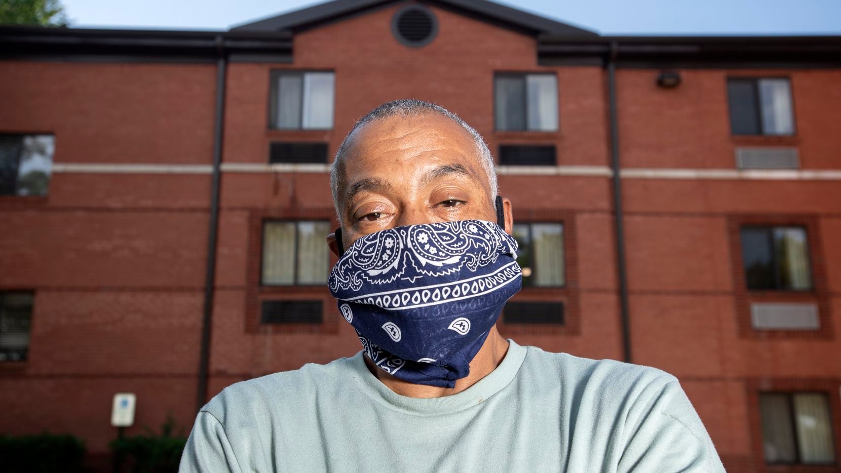 Terry Thompson poses for a portrait outside the extended stay hotel where he lives with his...