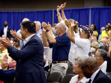 Delegates stand and applaud during the SDEC (State Democratic Executive Committee) meeting...