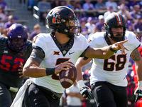 Oklahoma State quarterback Spencer Sanders (3) scrambles away from the TCU pass rush during...