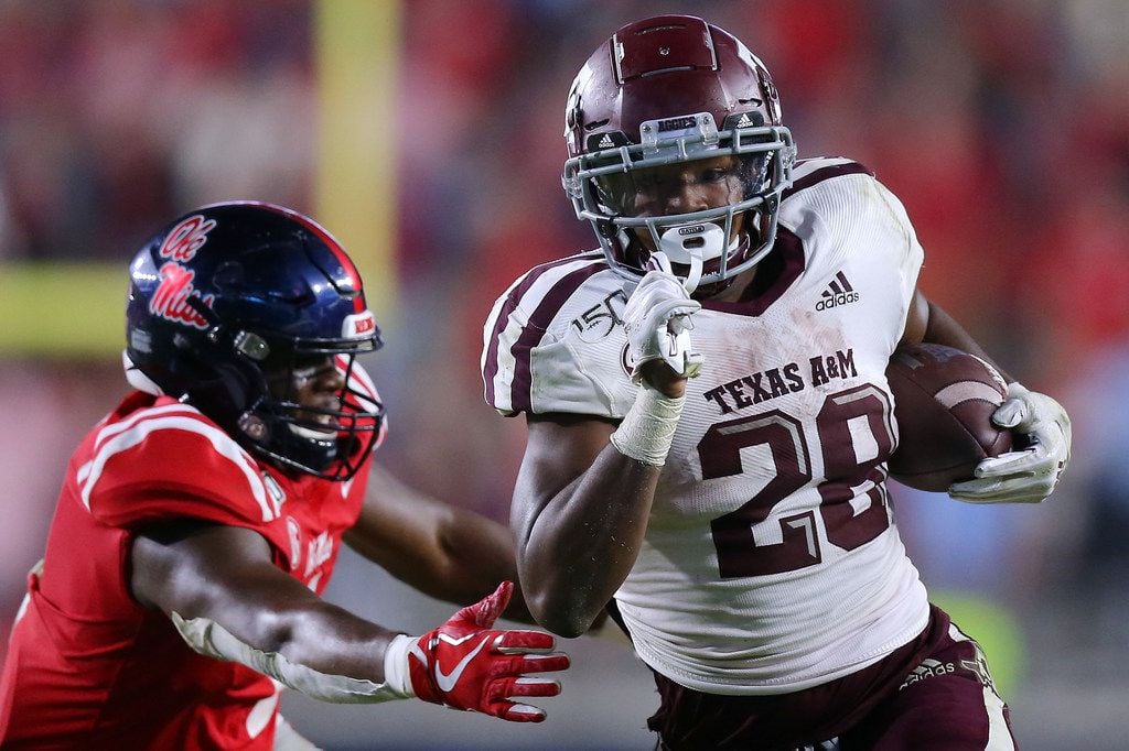 Isaiah Spiller #28 of the Texas A&M Aggies rushes for a touchdown as Lakia Henry #1 of the...