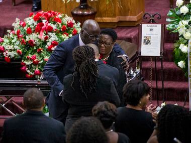 Dane Felicien embraces the Jean family after paying tribute to their son during the funeral...