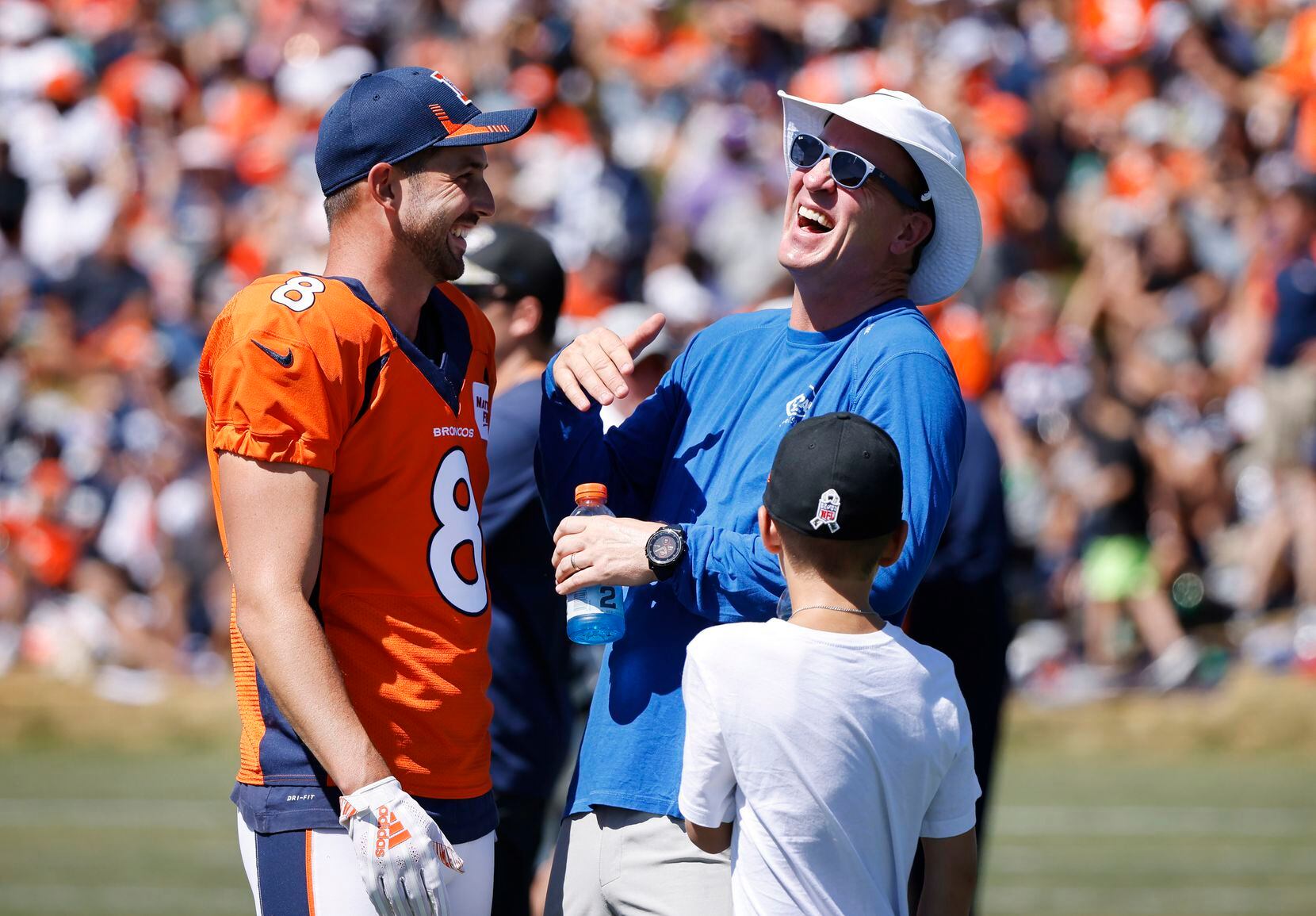 Former Bronco quarterback Peyton Manning (right) laughs with Denver Broncos kicker Brandon...