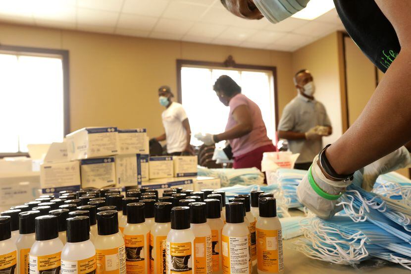Volunteers assemble kits of personal protective equipment at Friendship-West Baptist Church...