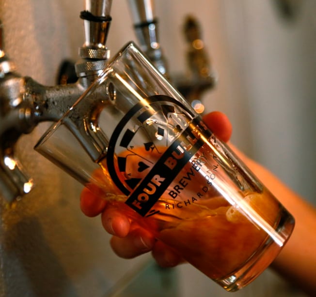 A beer is poured at Four Bullets Brewery in Richardson, Saturday July 25, 2015.