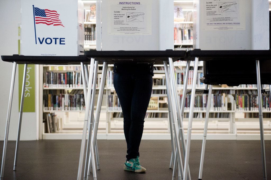 A voter takes advantage of early voting opportunities at a library.
