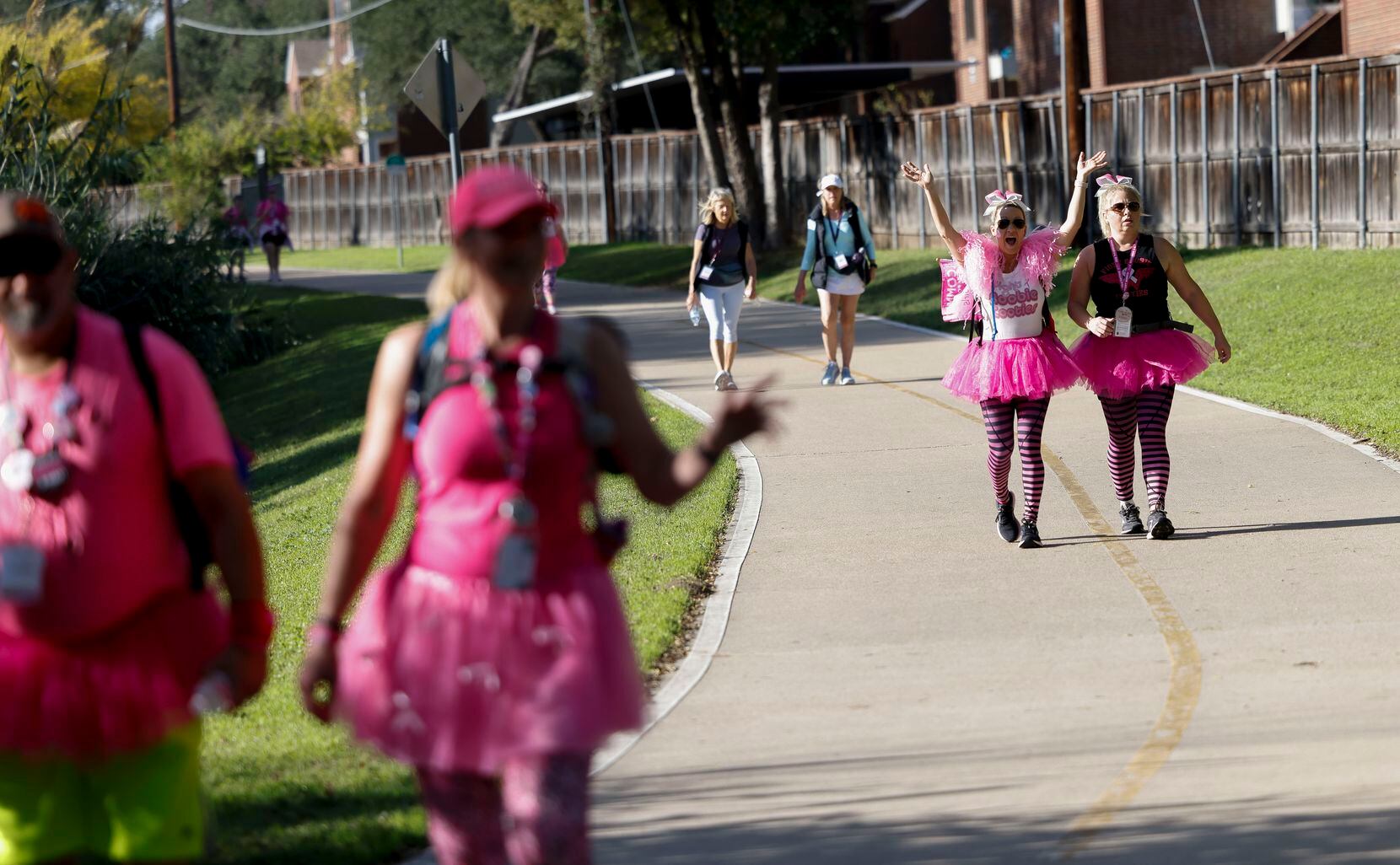 Breast cancer survivor Brenda Munden, second from right, and Melissa Muldowney walk on a...