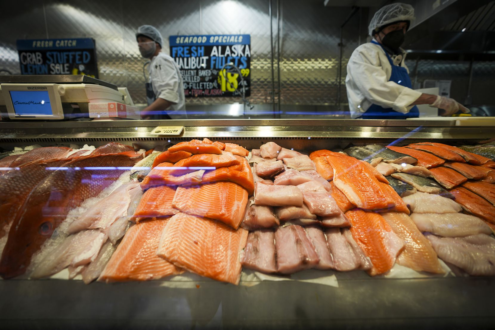 Workers in the seafood section at Central Market on Lovers Lane in Dallas.