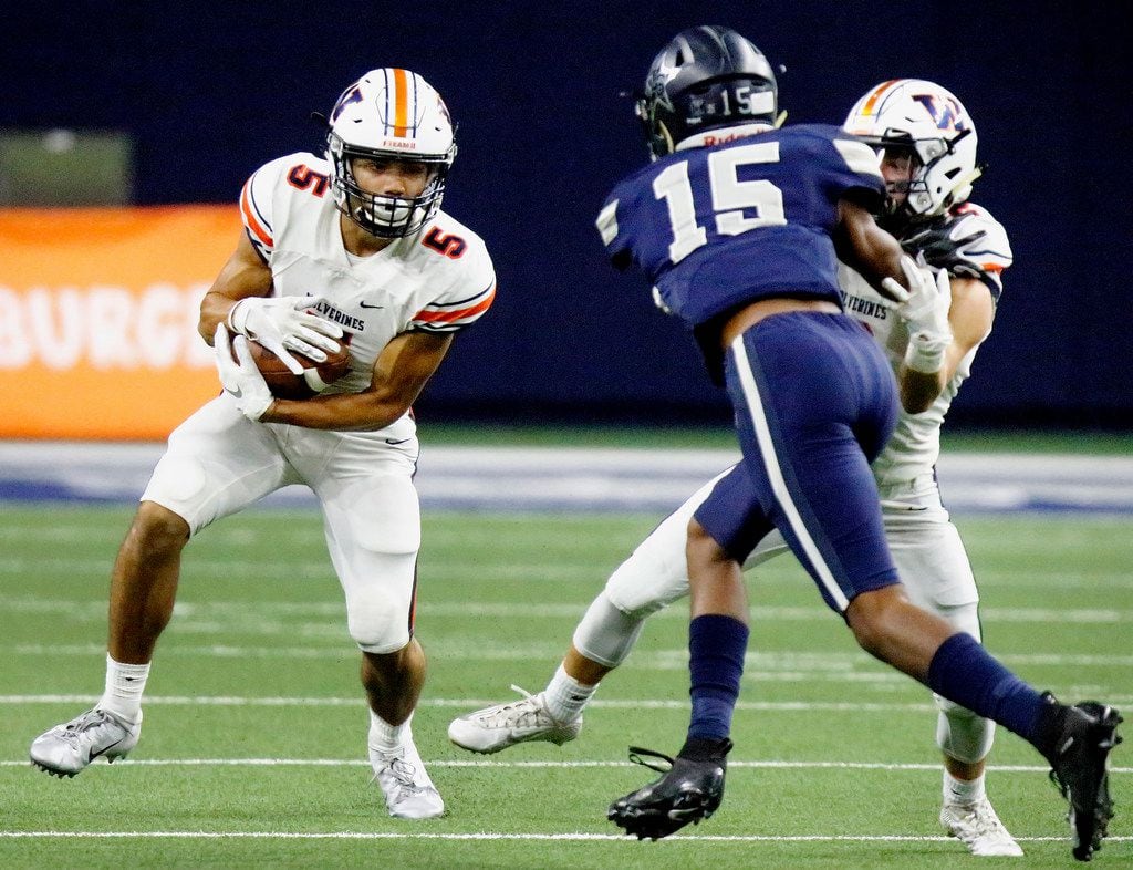 FILE - Wakeland High School wide receiver Kevin Rychel (5) looks for room to run as Lone...