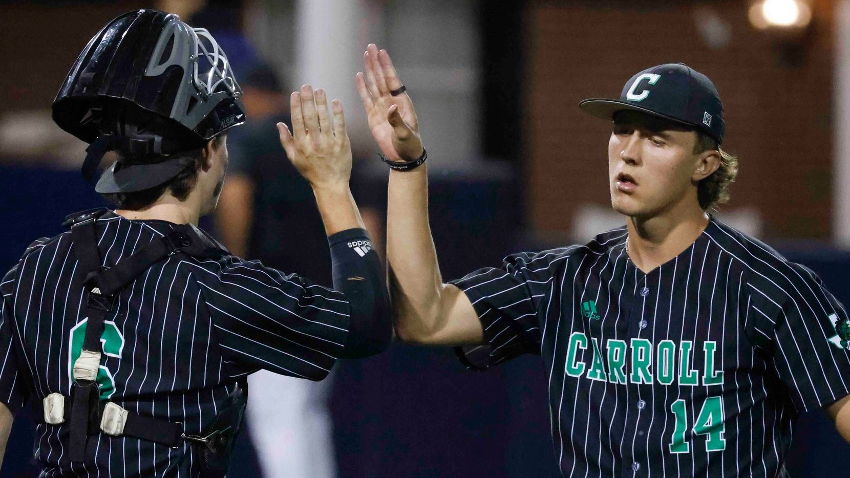 Southlake Carroll’s Griffin Herring, right, and Clark Springs hi5s during the sixth inning...