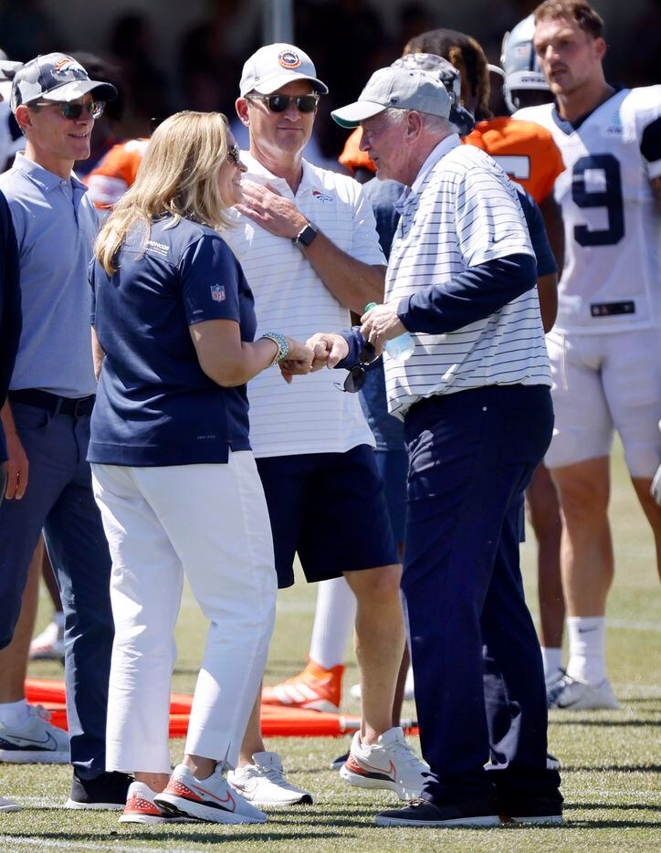 Dallas Cowboys owner Jerry Jones (right) fist bumps new Denver Broncos owners Carrie Penner...
