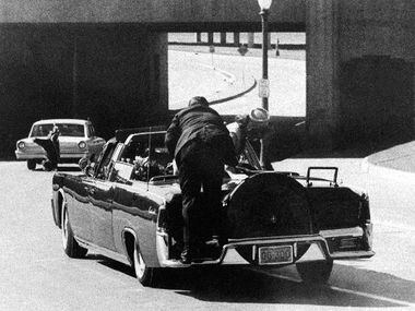 President Kennedy slumps down in the back seat of the limo after being shot in Dallas on...