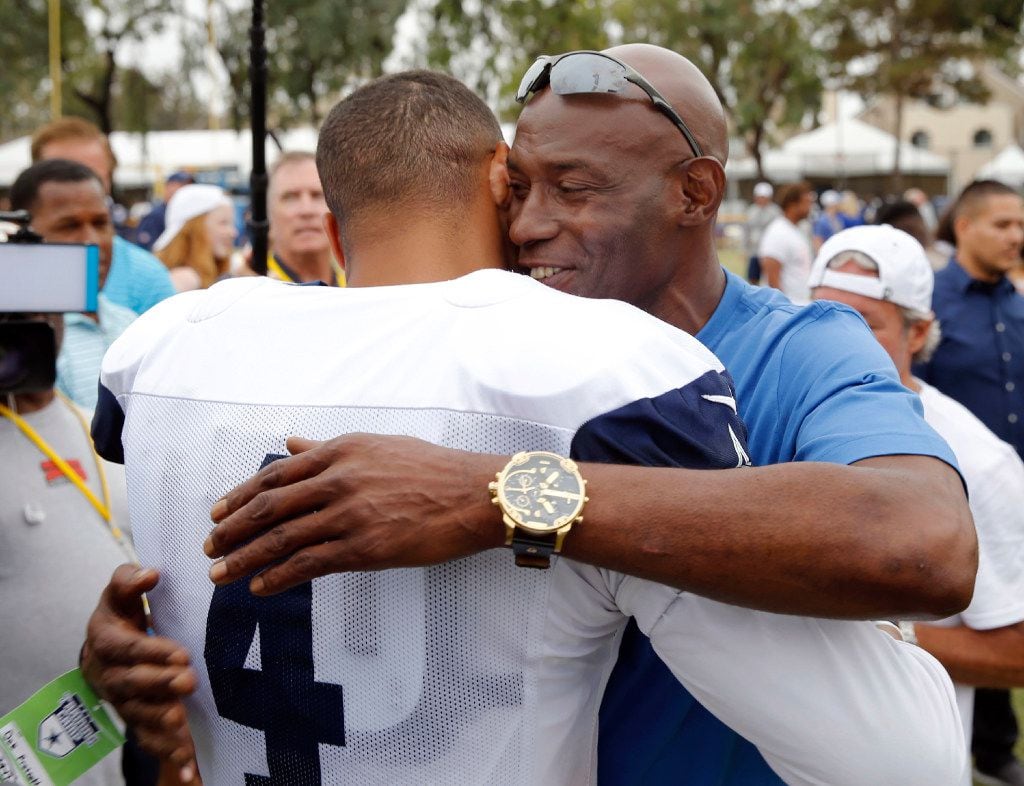 Dallas Cowboys quarterback Dak Prescott (4) gets a hug from his father Nathaniel "Nat"...