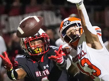 Rockwall defensive back Cadien Robinson (13) breaks up a pas intended for Rockwall-Heath...