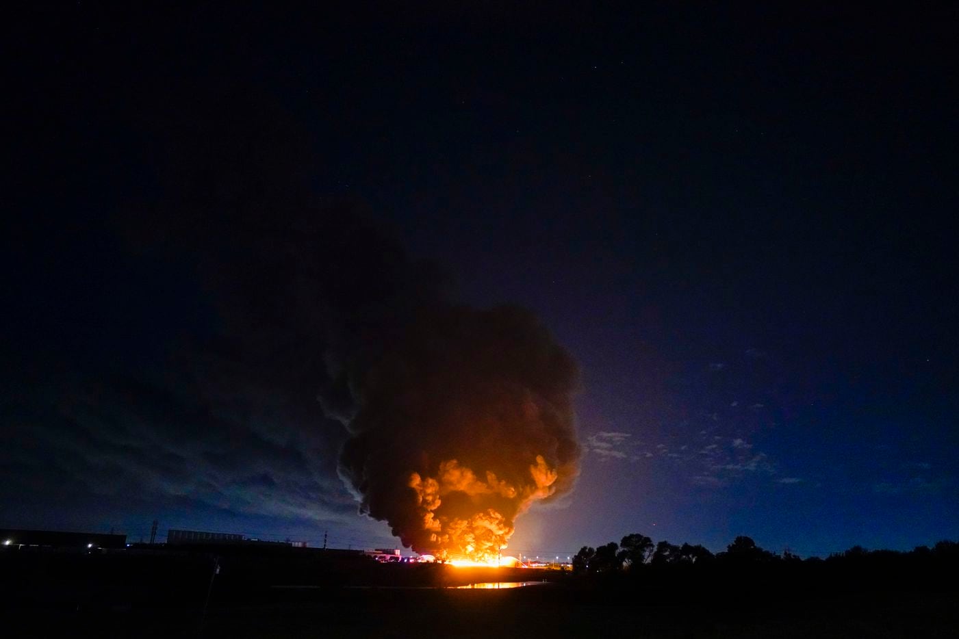 A plume of smoke is seen from a massive fire at  Poly-America on Wednesday, Aug. 19, 2020, in Grand Prairie.